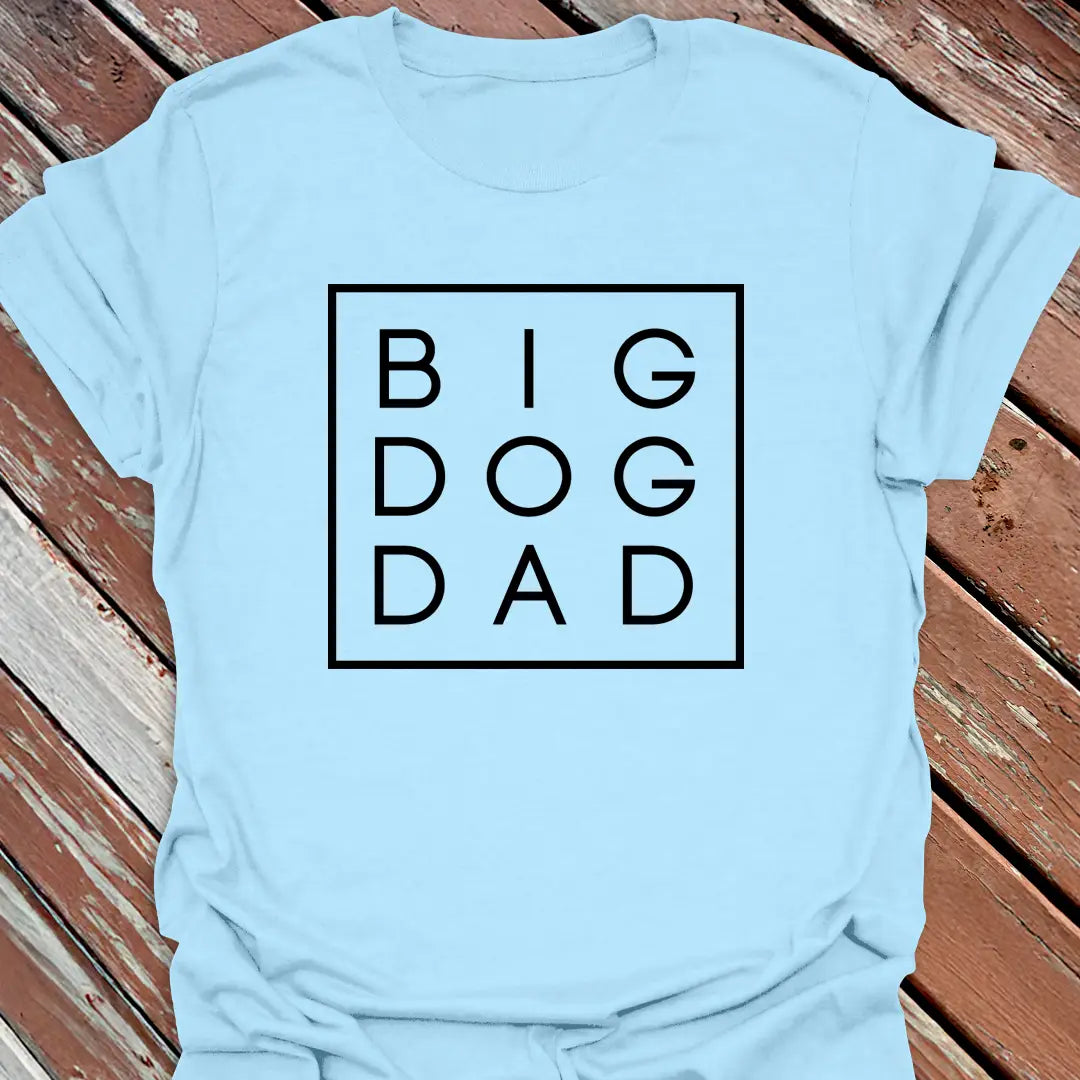 Big Woofer Wear light blue “Big Dog Dad” T-shirt for large breed dads, boxed text design on wood background