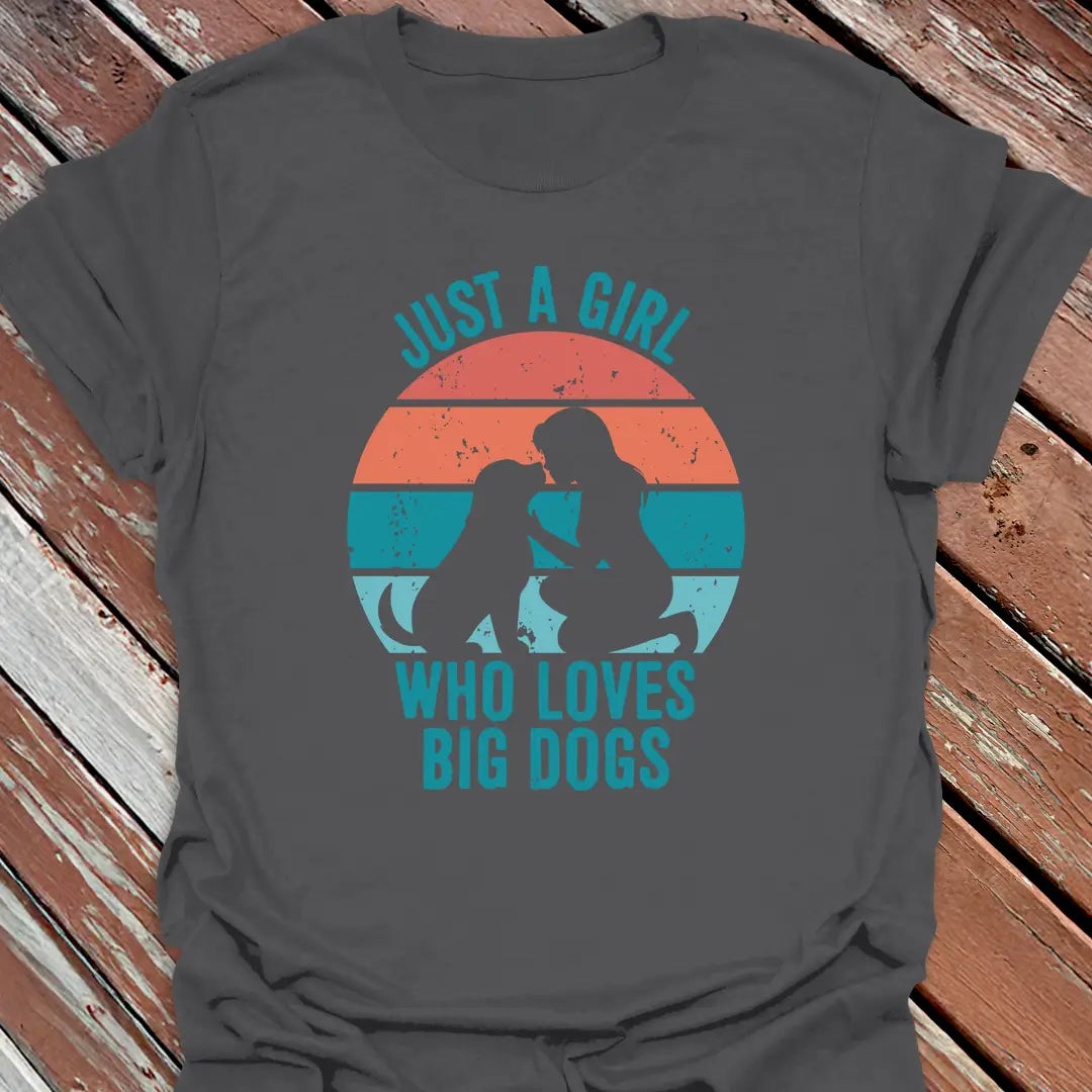 Charcoal Gray t-shirt with Just a Girl who loves big dogs design on a wooden surface.