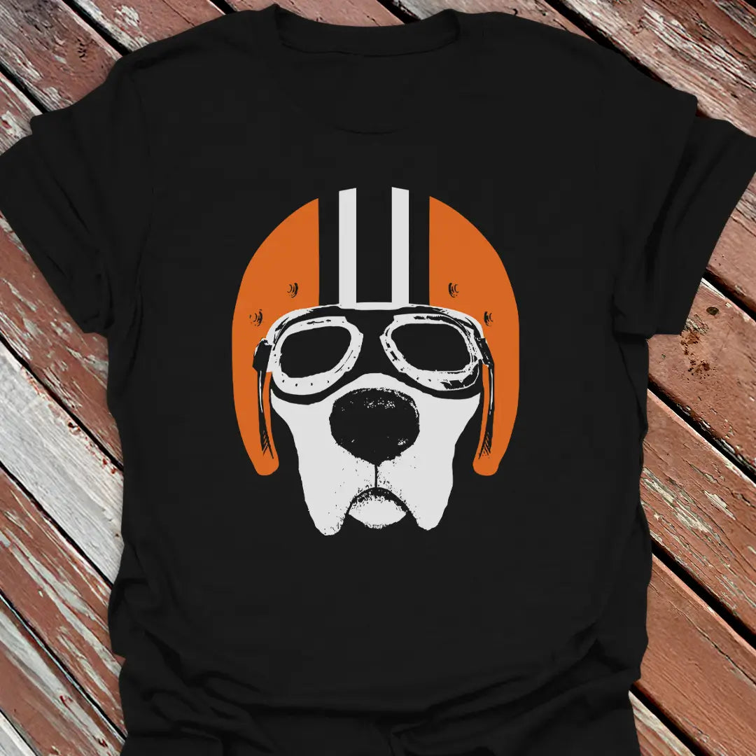Black road dog t-shirt with a labrador wearing goggles and an orange helmet graphic on a wooden surface.
