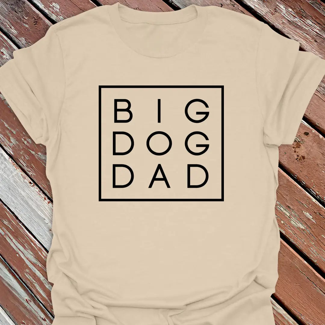 Big Woofer Wear sand “Big Dog Dad” T-shirt for large breed dads, boxed text design on wood background