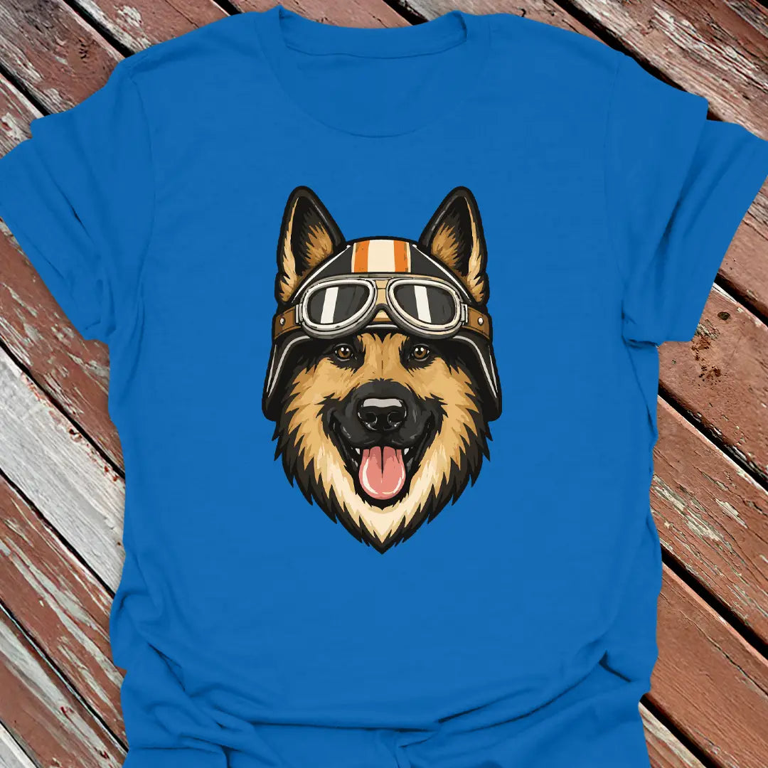 Royal blue t-shirt with a German Shepherd dog wearing a helmet and goggles on a wooden surface