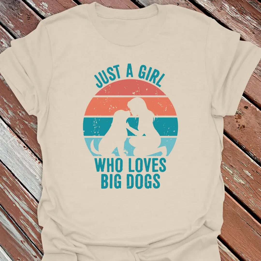 Natural t-shirt with graphic design and text 'Just a Girl Who Loves Big Dogs' on a wooden surface