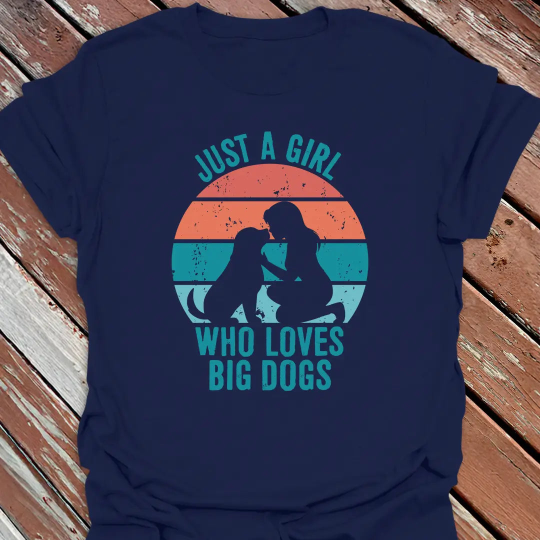 Navy blue t-shirt with Just a Girl who loves big dogs design on a wooden surface.
