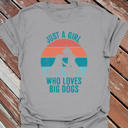 Gray t-shirt with Just a Girl who loves big dogs design on a wooden surface