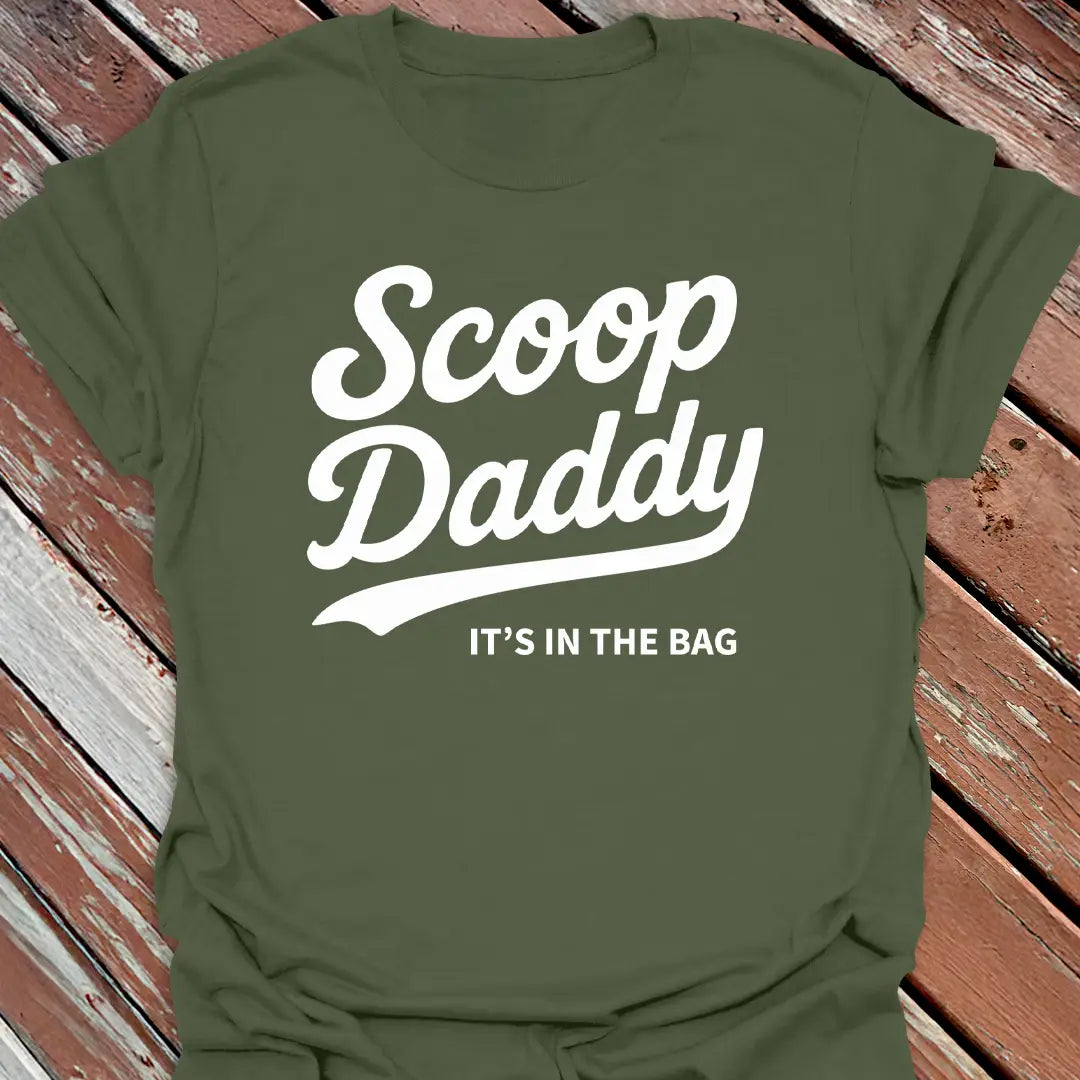 Big Woofer Wear military green “Scoop Daddy” T-shirt for big dog dads, bold scoop and paw design on wood background
