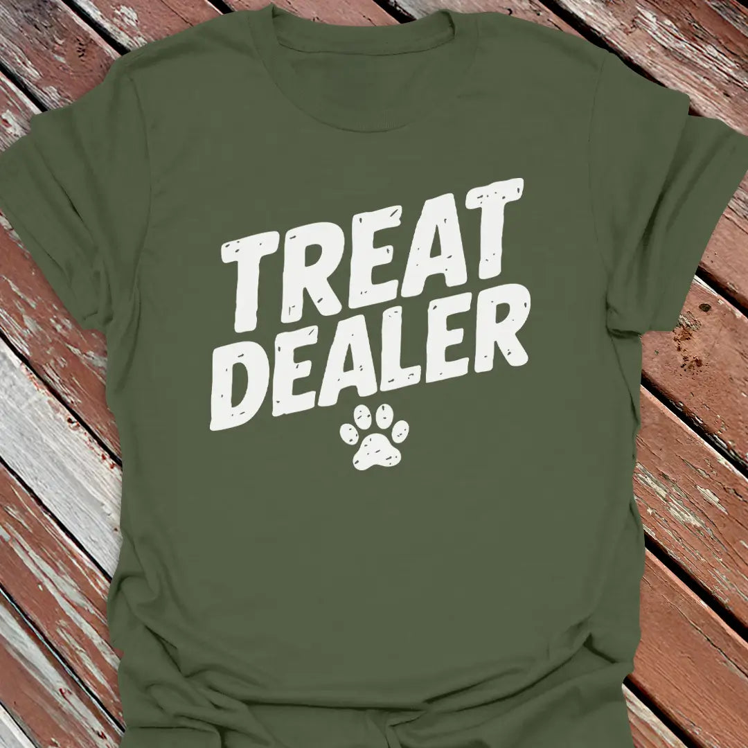 Green t-shirt with 'Treat Dealer' text and paw print on a wooden surface